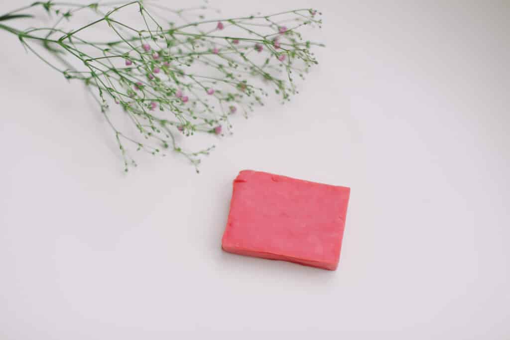 Natural handmade soap bar and flowers, spa organic soap on white background